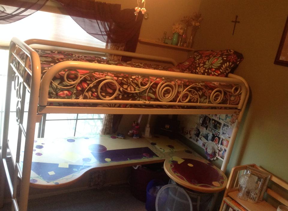 A bunk bed I converted for my daughter years ago. The bottom bunk was removed and made into a desk, I added height to the frame, and added decorative swirls on the sides.