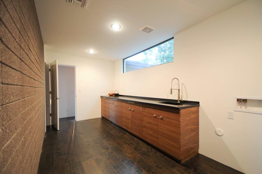 Hot rolled steel for a sink and counter, a window box, a laundry room counter, as well as cladding in the living room.