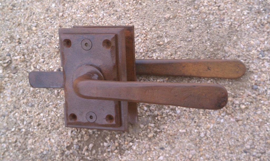 An interesting set of rust finished Colonial style gate latches for a wooden gate downtown in the historic district.